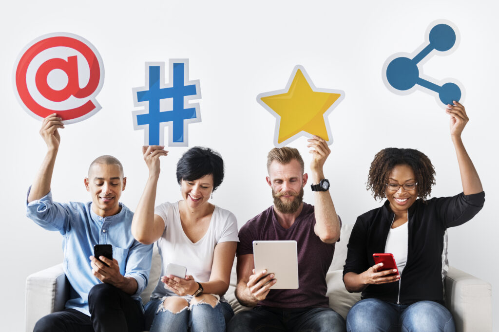 A brand awareness strategy team holding social media icons